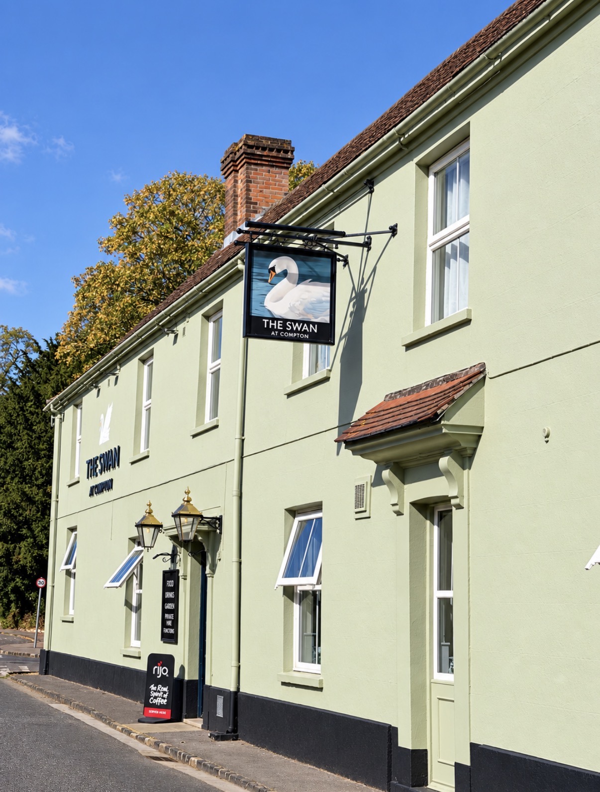 Exterior of The Swan at Compton village pub and sign