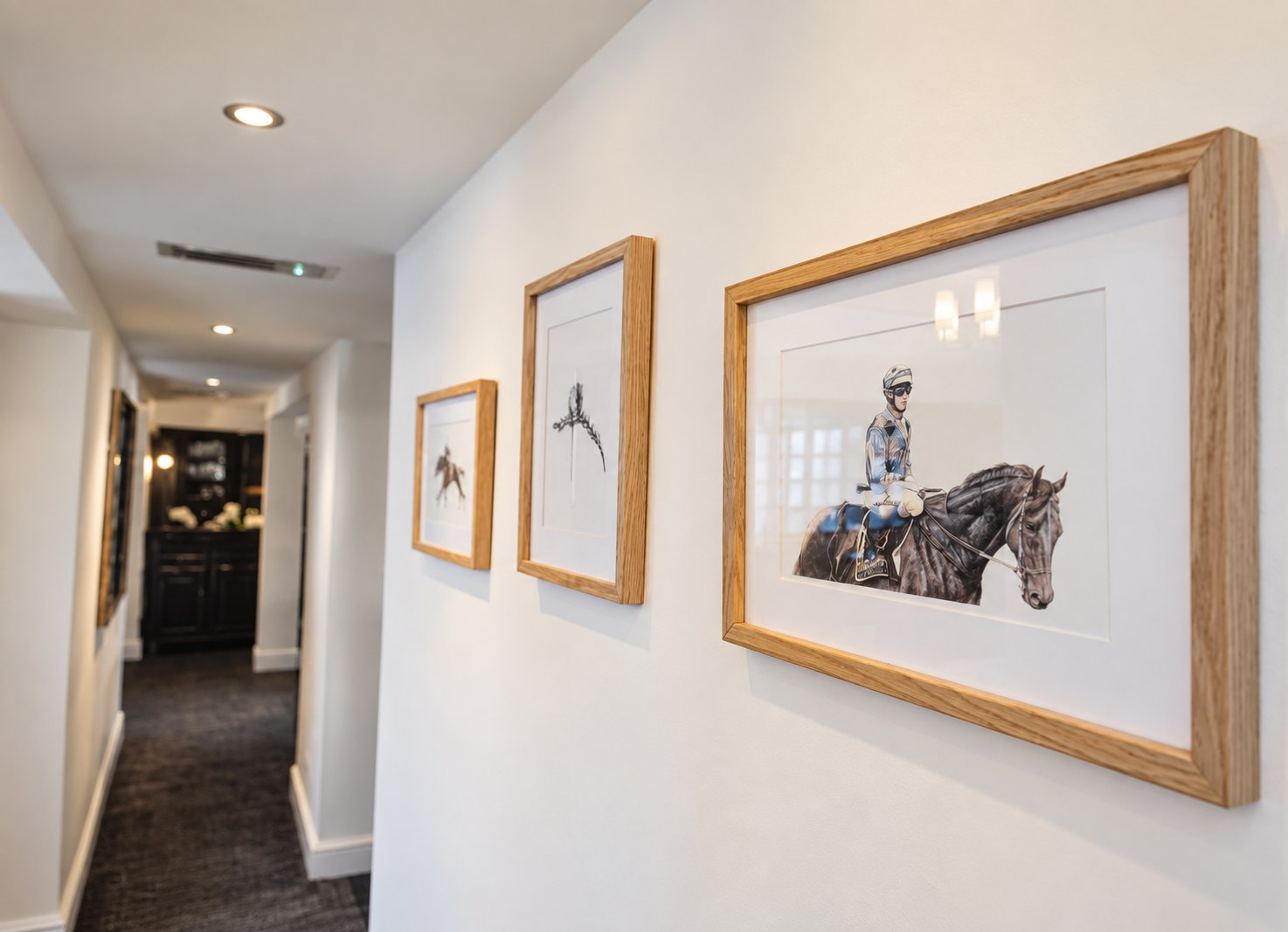 Framed artwork along the guest landing at The Swan at Compton