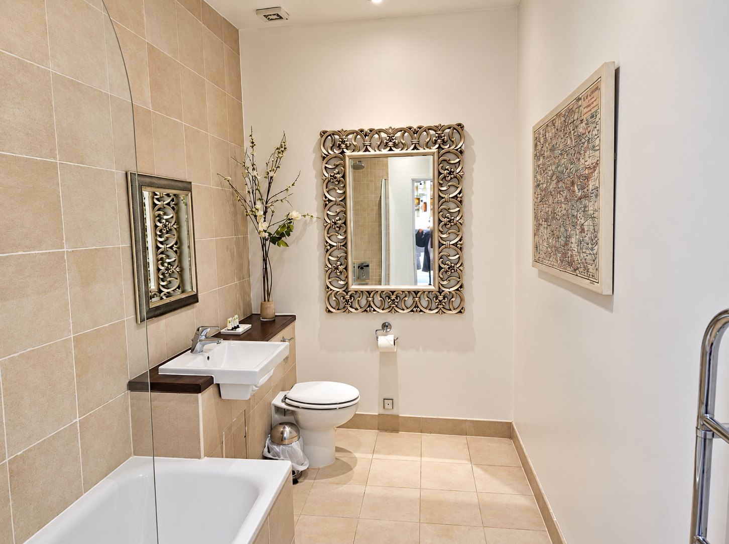 Guest bathroom at The Swan at Compton with a bath and framed mirror
