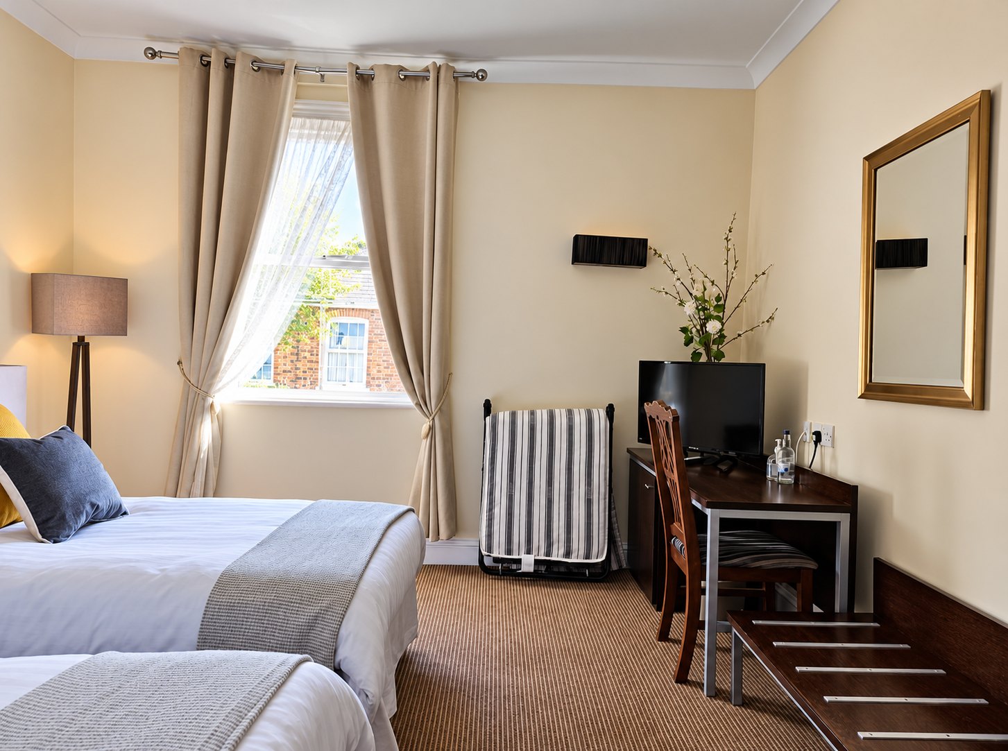Twin guest bedroom at The Swan at Compton with a dressing table